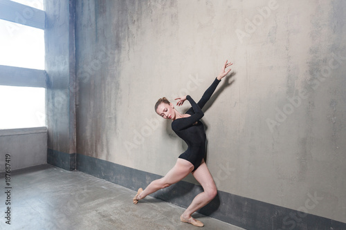 Ballerina movement in classic ballet posing near window