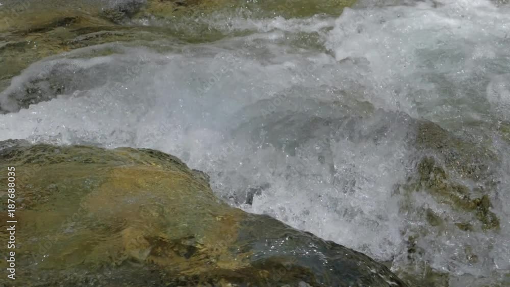 Beautiful water in a mountain river in slow motion video. Shooting speed 180fps, slow motion. Live shooting of the most beautiful nature river mountain water. The camera is not static. Beautiful water in a mountain river in slow motion video. Shooting speed 180fps, slow motion. Live shooting of the most beautiful nature river mountain water. The camera is not static.