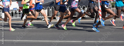 Photos marathon runners legs running on city road