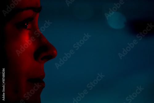 city lights shining on focused young woman's face at night