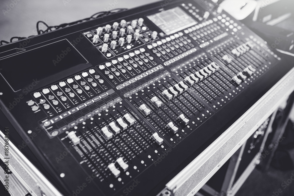 Wide angle photo of black sound mixer controller with knobs Wide angle photo of black sound mixer controller with knobs