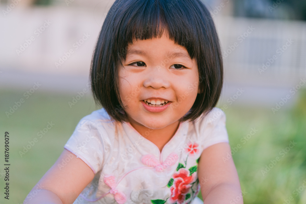 Happy Little asian girl in chinese traditional dress and smile.Chinese new year concept. Happy Little asian girl in chinese traditional dress and smile.Chinese new year concept.