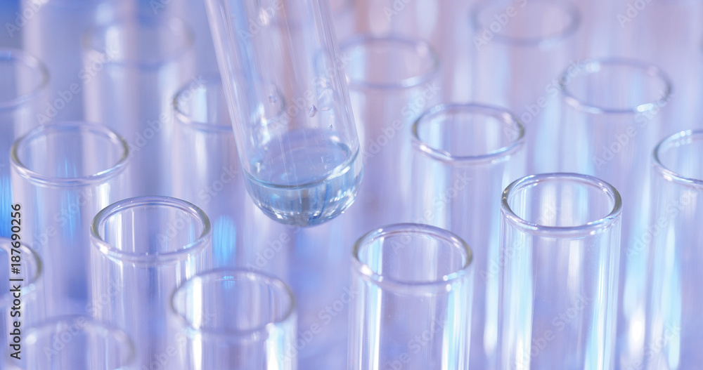 Pipette dropping sample into test tube Pipette dropping sample into test tube
