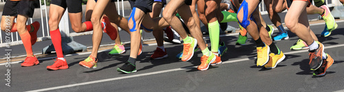 marathon runner legs running on city road © lzf
