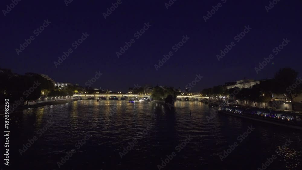 PARIS, FRANCE – SEPTEMBER 2016 : Video shot from bridge over Seine river at night with bridge and boat in view PARIS, FRANCE – SEPTEMBER 2016 : Video shot from bridge over Seine river at night with bridge and boat in view