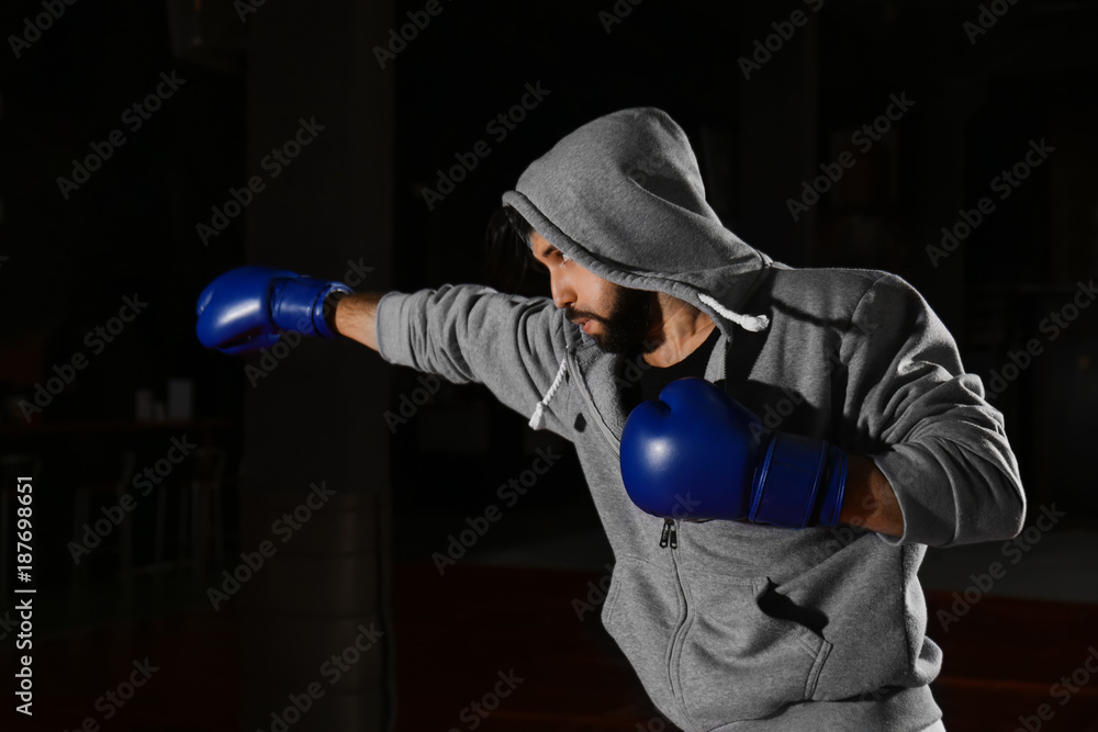 Young professional boxer training in gym Young professional boxer training in gym