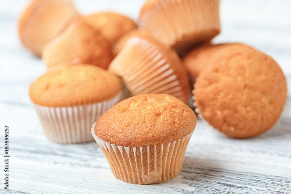 Delicious cupcakes on wooden table, closeup Delicious cupcakes on wooden table, closeup
