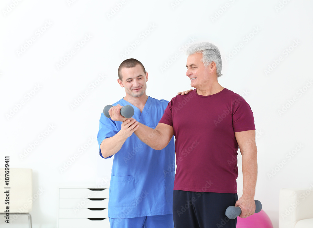 Physiotherapist working with patient in rehabilitation centre Physiotherapist working with patient in rehabilitation centre