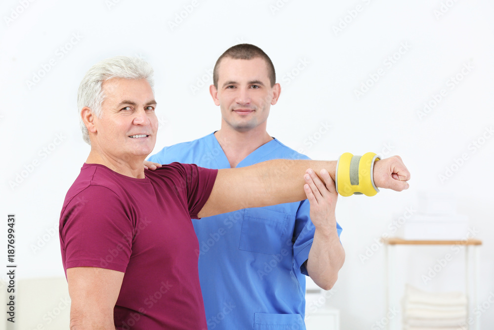 Physiotherapist working with patient in rehabilitation centre Physiotherapist working with patient in rehabilitation centre