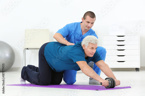 Physiotherapist working with patient in rehabilitation centre