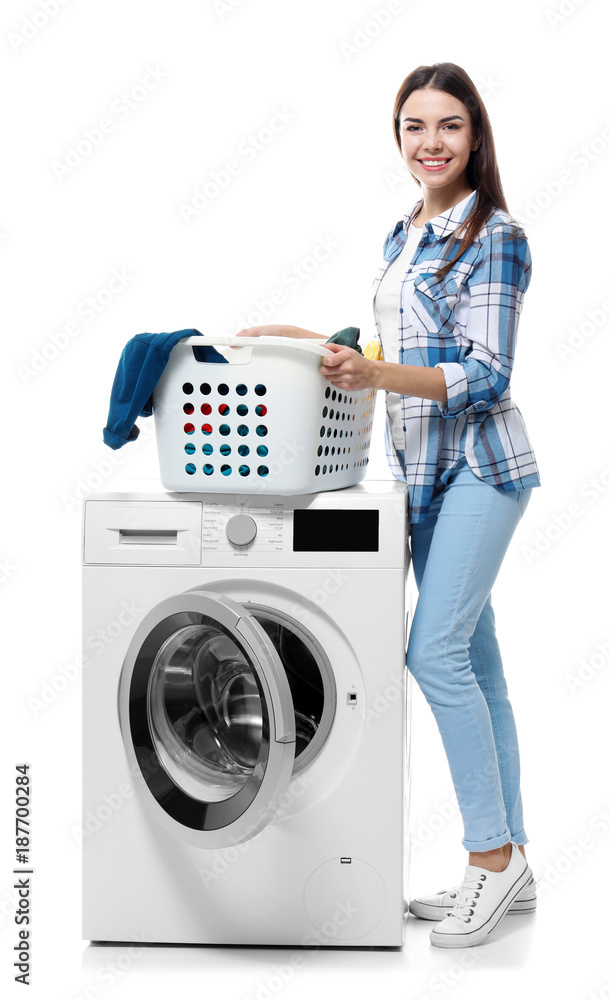 Young woman doing laundry on white background Young woman doing laundry on white background