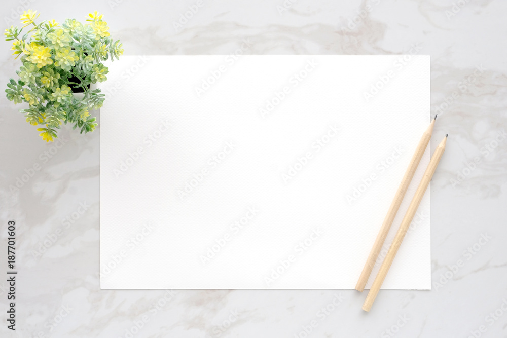Blank white note paper and pencils on white marble background, flat lay, top view, template Blank white note paper and pencils on white marble background, flat lay, top view, template