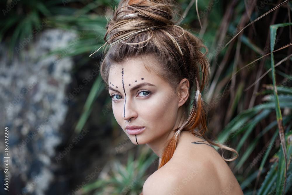 Young wild amazon with naked shoulders and feathers in her hair Young wild amazon with naked shoulders and feathers in her hair