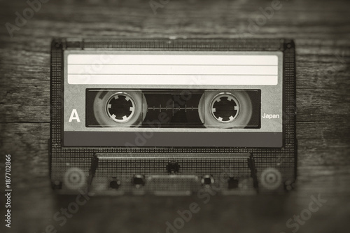 Fototapeta Retro stylized photo of vintage Audio cassette tape with blur and noise effect