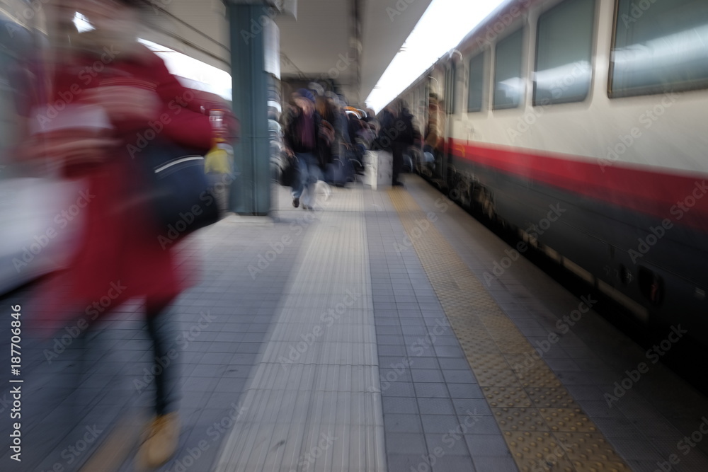 people out of focus at the train station