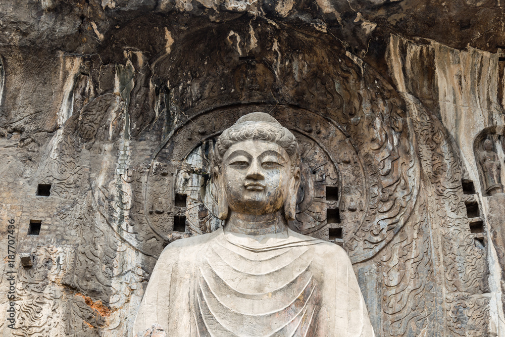 Main Buddha statue in Fengxiangsi Cave, the main one in the Longmen Grottoes in Luoyang, Henan, China. Longmen is one of the 3 major Buddhist caves of China, and a World heritage Site.