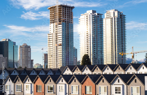 Brand new townhouses in a row on bright sunny day with Highrises in the background.