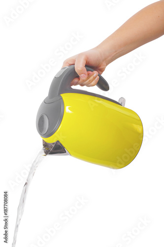A wife is holding a yellow kettle in his right hand and pouring water, isolated on white