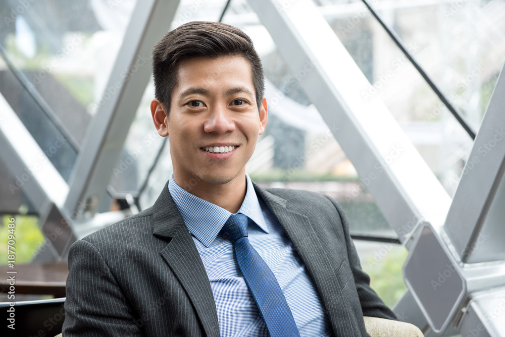 Young smiling handsome Asian Thai-Chinese businessman Young smiling handsome Asian Thai-Chinese businessman