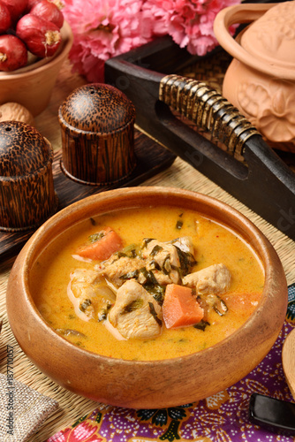 Chicken curry in wooden bowl 