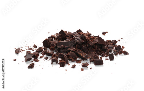 Pile chopped, milled cocoa chocolate bars and shavings isolated on white background