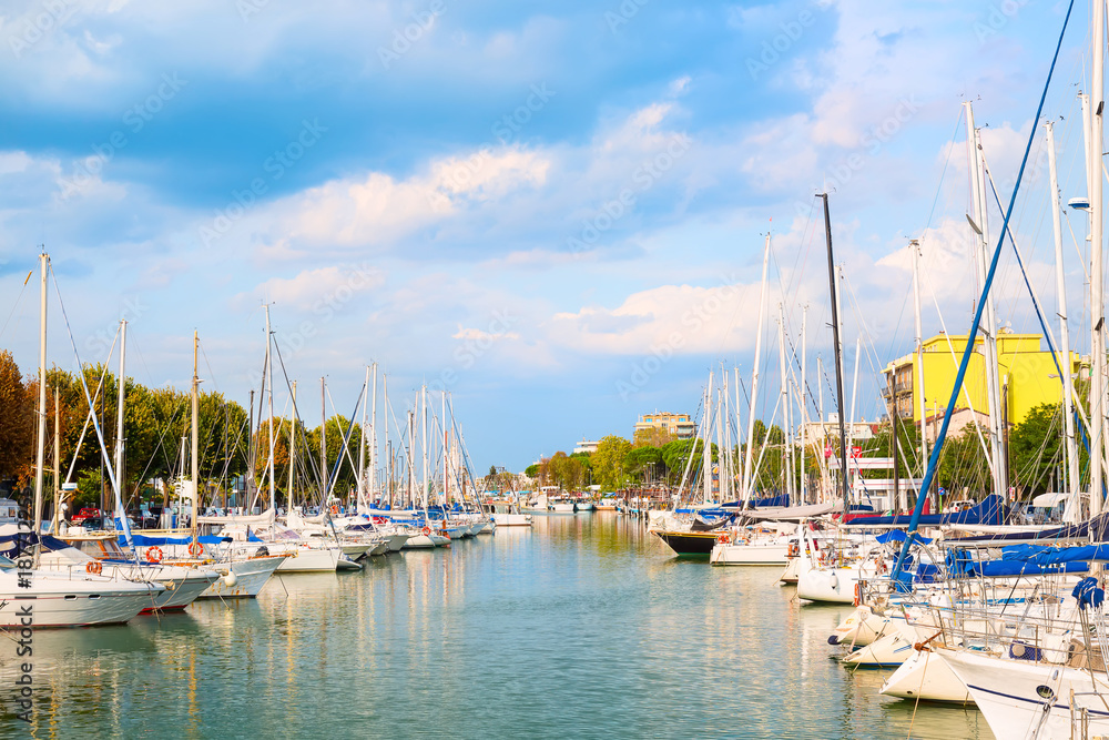 Naklejka premium Summer view of pier with ships, yachts and other boats in Rimini, Italy