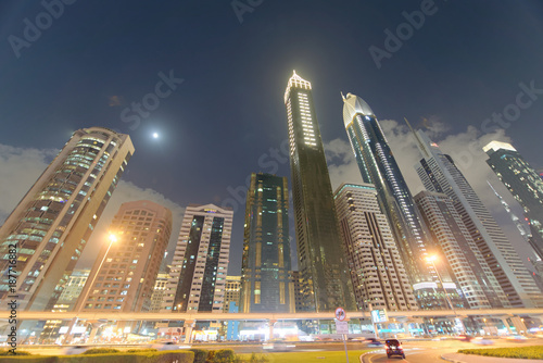 DUBAI, UAE - DECEMBER 11, 2016: Downrtown skyline along Sheikh Zayed Road at night as seen from rooftop. The city attracts 30 million tourists annually