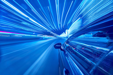 View from Side of Car moving in a night city, Blured road with lights with car on high speed. Concept rapid rhythm of a modern city.