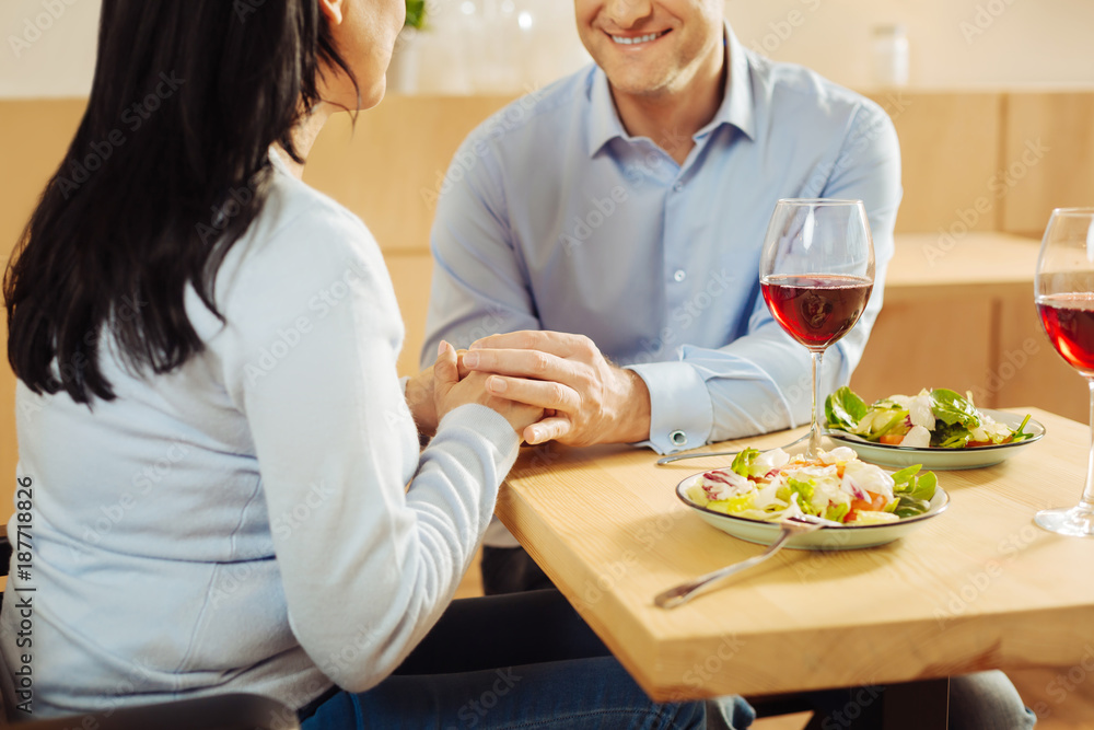 My love. Loving content disabled woman and a cheerful smiling well-built man sitting in a cafe and holding hands and having romantic dinner My love. Loving content disabled woman and a cheerful smiling well-built man sitting in a cafe and holding hands and having romantic dinner