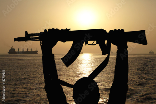 silhouette of machine gun in male hands