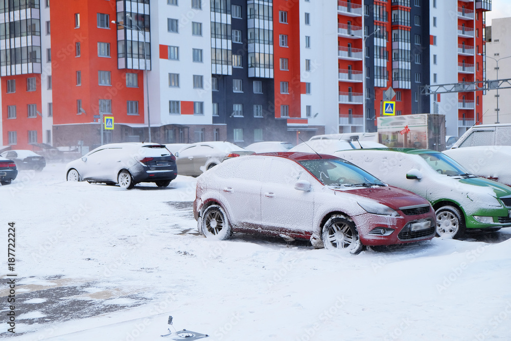snow-covered cars in the city
