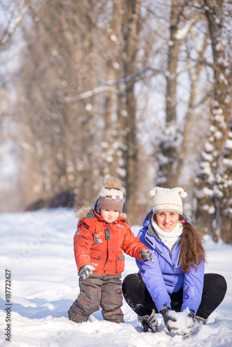 woman with a small child in the park for a winter walk.