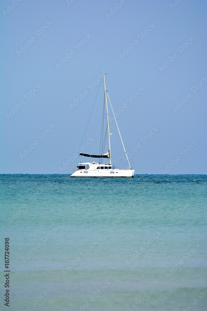 The white sailboat in the sea has the sky as the background,holiday travel in Thailand