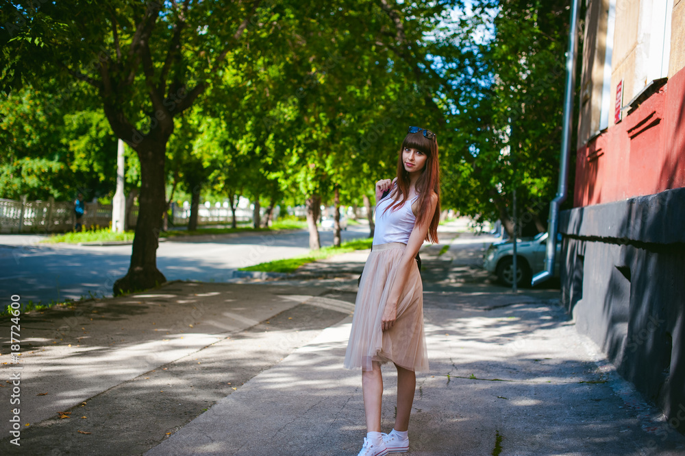 Young beautiful woman walking around the street on a warm sunny summer day