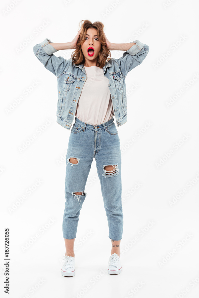 Full length image of Shocked woman in denim clothes Full length image of Shocked woman in denim clothes
