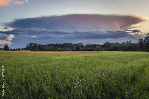 Evening clouds over fields near Gizycko town, Masuria region of Poland