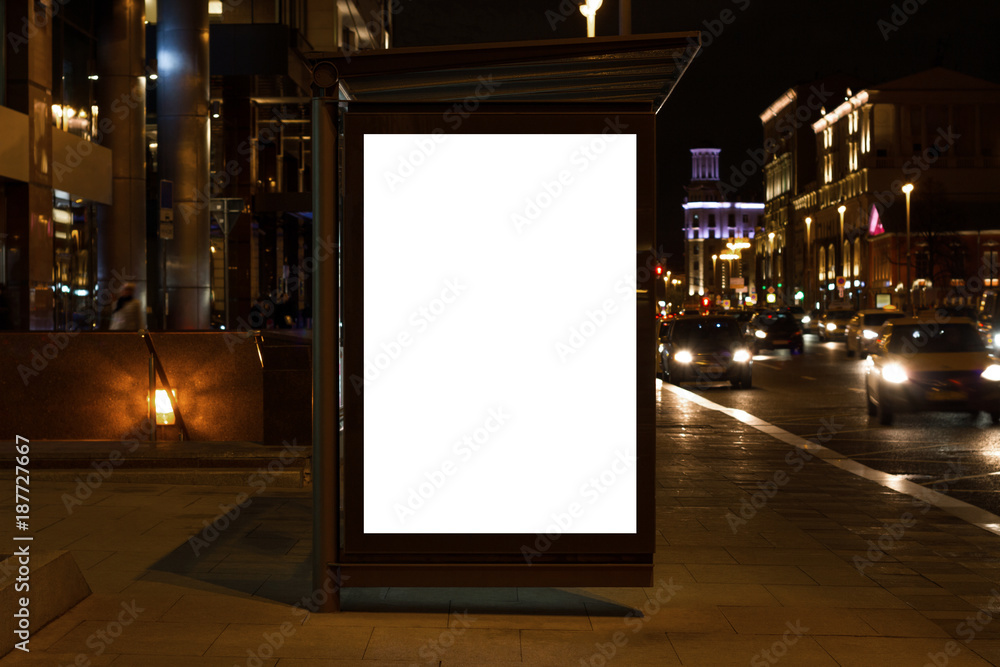 Blank white mock up of vertical light box in a bus stop at night - obrazy, fototapety, plakaty 