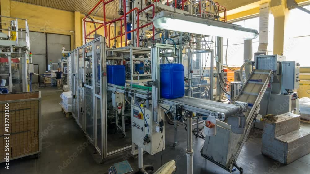 A factory for plastic canister production timelapse hyperlapse. The conveyor in the factory. A factory for plastic canister production timelapse hyperlapse. The conveyor in the factory.