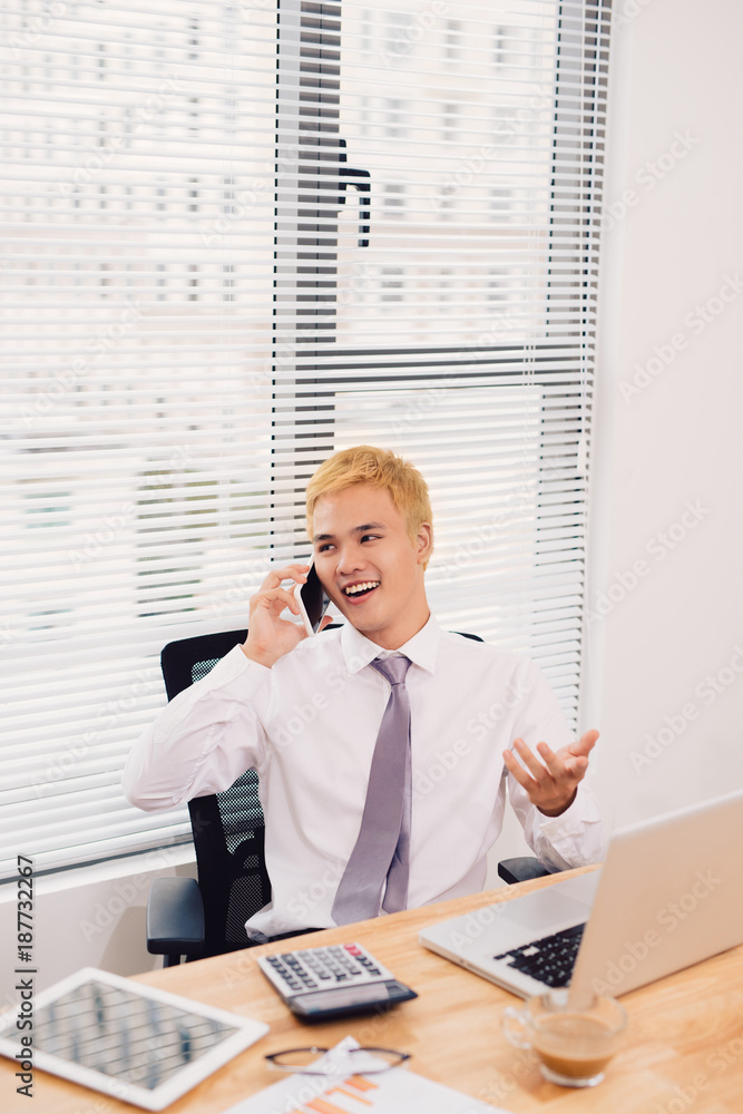 Happy Businessman on phone in office Happy Businessman on phone in office