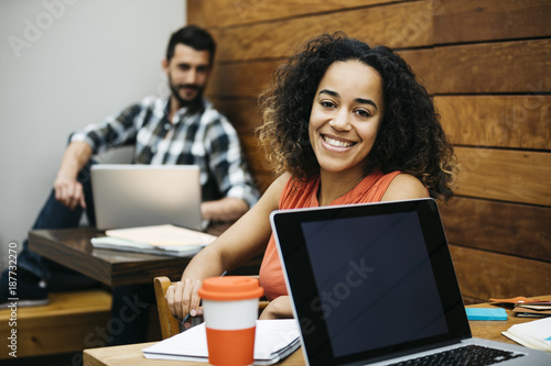 Content ethnic woman posing in office