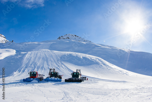 San Domenico, Varzo, Alps, Italy, three snowcats standing still on the ski slopes photo