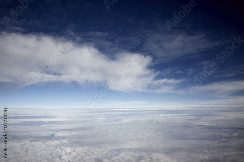 Fototapeta Naklejka Na Ścianę i Meble -  flying high in a blue sky with white clouds and sun shine