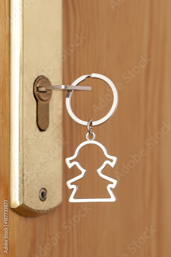 Keyring with a female shape in the lock of an entrance door