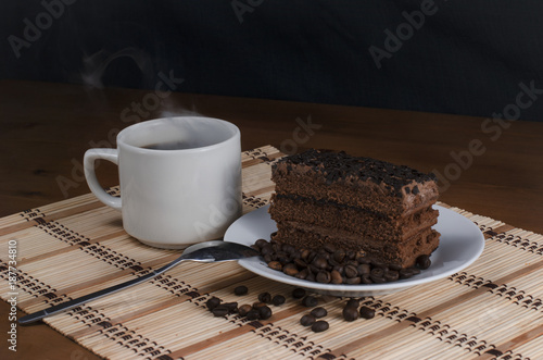 slice of tasty cake with a cup of hot coffee photo