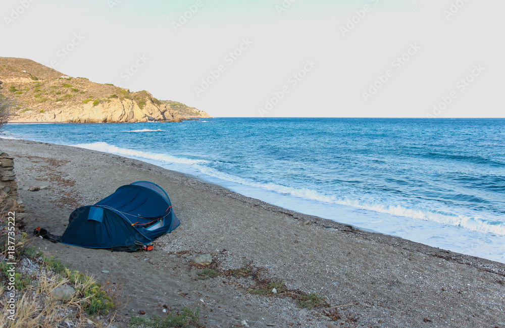 blue tent on the beach with beautiful blue wavy seascape blue tent on the beach with beautiful blue wavy seascape