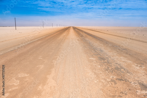 Endless straight sand and gravel roads crossing the Namib desert  Namibia