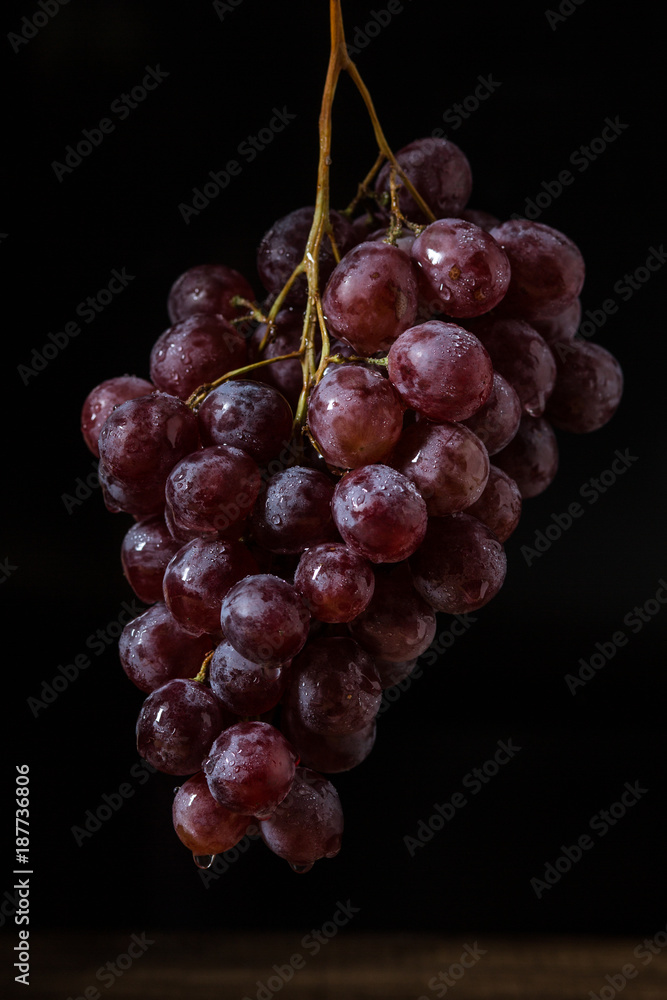 Fototapeta premium Hanging fresh red grapes, vintage style.