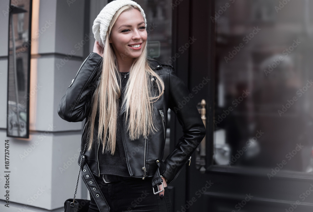Portrait of beautiful young blonde woman wearing stylish black outfit, she smiling on urban background, happy time, Travel Concept.trendy girl in stylish sunglasses ad leather jacket in the street. Portrait of beautiful young blonde woman wearing stylish black outfit, she smiling on urban background, happy time, Travel Concept.trendy girl in stylish sunglasses ad leather jacket in the street.