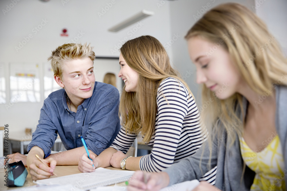 Teenagers talking in classroom Teenagers talking in classroom