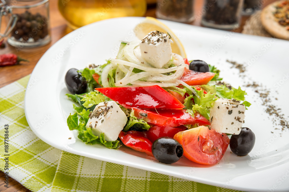 plate of green salad with vegetables, top view,